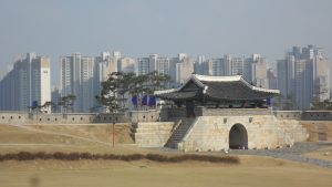 Suwon's fortress from within the walls with typical residential tower blocks behind